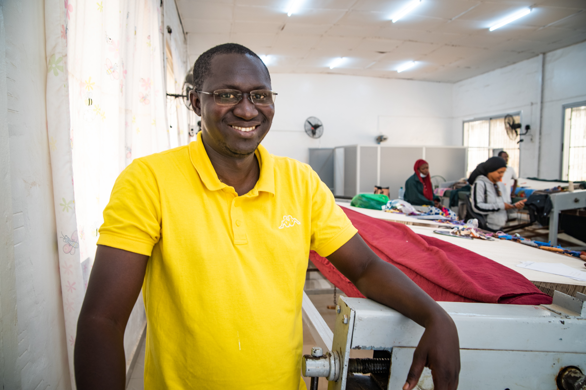 Skilled Senegalese weavers producing a handcrafted tapestry on traditional looms at the Manufacture Sénégalaise des Arts Décoratifs in Thiès.